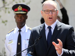 Coun. Scott Gillingham (centre) and Police Chief Devon Clunis. (Brian Donogh/Winnipeg Sun file photo)