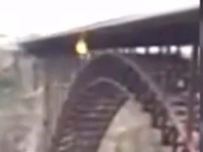 Image taken from a YouTube video showing parachutist Jim Hickey's failed stunt where he attempted to burn his parachute while BASE jumping off the Perrine Bridge into the Snake River in Idaho. (YouTube)