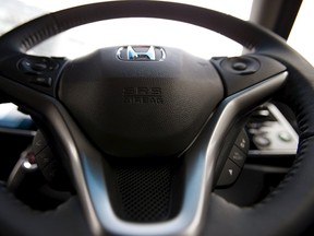 An airbag logo is seen on a steering wheel of Honda Motor Co's all-new hybrid sedan Grace, in which an airbag made by Takata Corp has been installed, during its unveiling event in Tokyo, in this December 1, 2014 file photo. (REUTERS/Toru Hanai/Files)