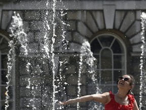 A woman cools down at the fountains at Somerset House in central London, April 15, 2015. REUTERS/Toby Melville