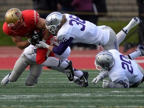 The Bombers signed defensive back Justin Warden (36), seen here making a tackle in a university game last October. (DIDIER DEBUSSCHERE/POSTMEDIA NETWORK FILE PHOTO)