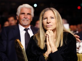 Singer Barbra Streisand and husband actor James Brolin listen to U.S. President Barack Obama speak after receiving the Ambassador for Humanity Award at the USC Shoah Foundation 20th Anniversary Gala in Los Angeles May 7, 2014. 
REUTERS/Kevin Lamarque