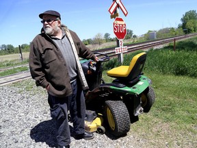 Reg Bowls narrowly escaped serious injury when his riding lawn mower was clipped by a Via passenger train east of Chatham, Ont., in the hamlet of Northwood. (DIANA MARTIN/Postmedia Network)