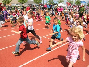 Kindergarten children leave the start line for their final half-marathon laps at the Caraco Field track, part of the Marathon Club project. (Michael Lea/The Whig-Standard)