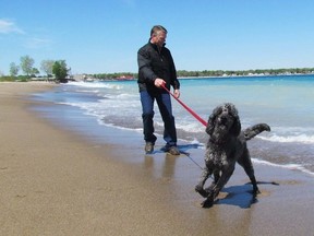 Jon Taylor walks his dog Tessa along Lake Huron on Wednesday May 20, 2015 in Sarnia, Ont. Sarnia's Canatara Park beach has once again been designated a Blue Flag Beach by the organization Environmental Defence. (Paul Morden, The Observer)