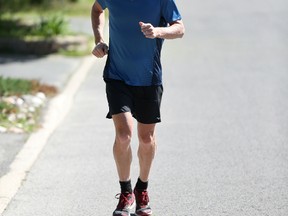 Ottawa triathlete Rick Hellard runs near his west-end home on Wednesday.Hellard, who had a pacemaker installed to treat a heart problem over a year ago, is competing in the upcoming Tamarack Ottawa Race Weekend. ​(Chris Hofley/Ottawa Sun)