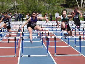 Athletes compete in the junior girls 80 metre hurdles at the local high school track and field championships at Laurentian University track in Sudbury, Ont. on Wednesday May 20, 2015.