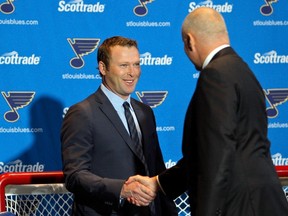 Martin Brodeur (left) shakes the hand of Blues GM Doug Armstrong before announcing his retirement in January. Brodeur is now the Blues assistant GM. (Scott Kane/USA TODAY Sports)