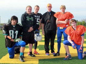 The Sarnia Sturgeons bantam football team is preparing to start the 2015 Ontario Football Conference season. From left are team captains defensive tackle Cole Rogers, linebacker Mitchell Hillsdon, middle linebacker Matt Kirk, head coach Dave Clark, quarterback Hunter Hendrie and tight end Nathan Clark. Absent is running back/full back Cam Havers. (Terry Bridge, The Observer)