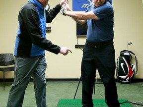 GolfTEC instructor Blair Buttar works with Sun writer Con Griwkowsky on his backswing during a session at the indoor training facility last week. (Tom Braid, Edmonton Sun)