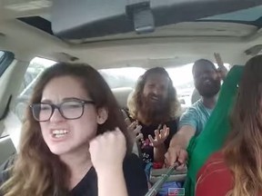A screengrab of four friends singing on a road trip using a selfie stick. (YouTube/Screengrab)
