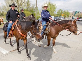 M. Cpl. Paul Nichols (L) of the Fourth Canadian Ranger Patrol rides his horse Zoe next to Sgt. (Ret.) Kurtis Sanheim, formerly with the Calgary Highlanders, in downtown Calgary, Alta., on Friday, May 8, 2015. Nichols, who was formerly a member of the Calgary Highlanders, is riding Zoe across Canada in support of PTSD awareness. Lyle Aspinall/Calgary Sun