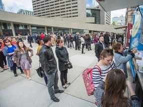 People line up for lunch as a part of Food Truck Freedom Day at Nathan Phillips Square in front of City Hall in Toronto onMay 13, 2015. (Ernest Doroszuk/Toronto Sun)