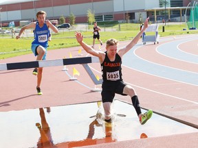Liam Passi, front, of Lasalle Secondary School, and Tie Pylatuk, of Ecole secondaire du Sacre-Coeur, compete in the open boys 2,000 metre steeplechase race at the local high school track and field championships at the track at Laurentian University in Sudbury, Ont. on Thursday May 21, 2015.