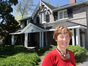 Marion Westenberg, chair of this Saturday's annual Kingston Symphony Music Lovers' House Tour, stands in front of Barberry Cottage on Centre Street, one of eight homes on the tour. (Michael Lea/The Whig-Standard)