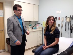 Dr. John Mackey and patient Kimberley Boulton speak at the Cross Cancer Institute at 11560 University Ave., in Edmonton, Alta., on Thursday, May 21, 2015, which is International Clinical Trials Day. Boulton is participating in a clinical trial to treat HER-2 positive breast cancer with experimental biological drugs instead if the standard chemo therapy. Catherine Griwkowsky/Edmonton Sun/Postmedia Network