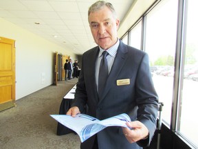 Dean Edwardson, general manager of the Sarnia-Lambton Environmental Association, holds a copy of the group's 2014 progress review and technical summary, before presenting the information at the association's annual meeting on Thursday May 21, 2015 in Sarnia, Ont. (Paul Morden/Sarnia Observer/Postmedia Network)