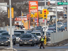 An Ottawa Police Officer directs traffic at the corner of Carling Ave. and Maitland Avenue. Errol McGihon/Ottawa Sun files