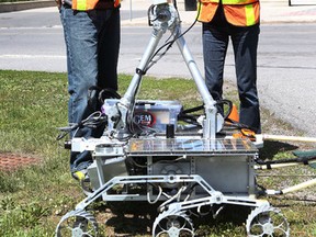 Research assistant Andrew Hay and Claire Samson, Carleton University professor in Earth Sciences, work on a KAPVIK Mars rover at Carleton University in Ottawa Ont. Thursday May 21, 2015.   Tony Caldwell/Ottawa Sun/Postmedia Network