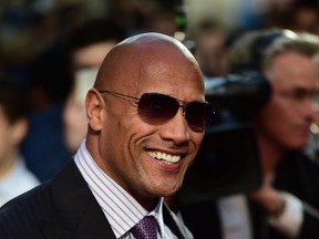 Actor Dwayne 'The Rock' Johnson poses on the carpet as he arrives to attend the World premiere of the film 'San Andreas' in London on May 21, 2015.  AFP PHOTO / LEON NEAL