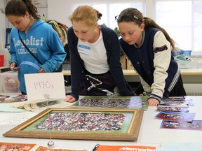 BRUCE BELL/THE INTELLIGENCER
Queen Elizabeth School in Picton celebrated its 60th anniversary Thursday evening. Pictured are current students (from left) Isabel Burfoot-Clark, Anna Louder and Sarah Johnson looking over some memorabilia from the 1970’s.