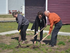 Judy Bennett (left), AnnLisa Jensen (centre) and Duncan Schoepp (right) break ground for a replica of the old Stony Plain Town Hall at the Pioneer Museum on May 14. - Kyle Muzyka, Reporter/Examiner