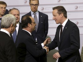 Britain's Prime Minister David Cameron (R) shakes hands with France's President Francois Hollande before the Eastern Partnership Summit session in Riga, Latvia, May 22, 2015. REUTERS/Ints Kalnins