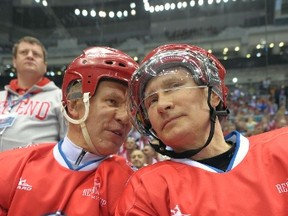 Russian President Vladimir Putin (R) talks to retired Russian ice hockey player Viacheslav Fetisov as he takes part in a gala match of the National Amateur Ice Hockey Teams' Festival organized by the Night Ice Hockey League in Sochi, May 10, 2014. REUTERS/Alexei Druzhinin/RIA Novosti/Kremlin