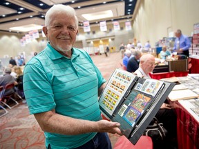 Stamp collector Woody Brooks shows off some of his collection while taking a break from negotiating with a dealer at the Royal Philatelic Society convention, hosted by the Middlesex Stamp Club at the London Convention Centre this weekend. (CRAIG GLOVER, The London Free Press)