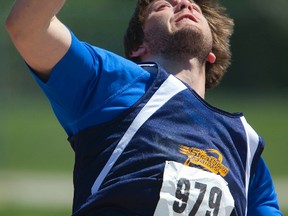 Andrew Martin of Strathroy unleashes a put on his way to winning the senior boys shot put with 16.97 metres on Day 2 of the WOSSAA track and field meet at Western University on Friday. At left, Natalie Topp of St. Marys pushes to the line ahead of Lexi Aitken of Clinton St. Anne?s to win the senior girls 200m. (MIKE HENSEN, The London Free Press)