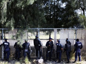 Federal policemen guard a ranch where a gunfight between hitmen and federal forces left several casualties in Tanhuato, state of Michoacan, May 22, 2015. (ALAN ORTEGA/Reuters)