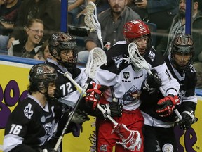 Calgary forward Curtis Dickson is surrounded by Edmonton Rush players during last Friday's NLL playoff action (Tom Braid, Edmonton Sun
