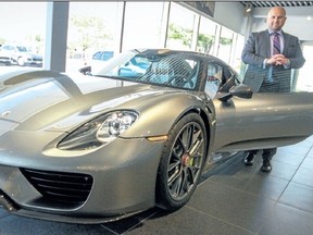 Tim Bamford, sales specialist at Porsche of London, shows off the $1.4-million Porsche 918 Spyder. Bamford, a St. Thomas native, spent more than a year brokering the deal on the custom car, which was manufactured by hand in Germany and bought by an unnamed client in the region.  (Supplied photo)