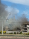 Crews battle the flames at an apartment building near 50 Street and Manning Drive Friday afternoon. (Max Maudie photo)