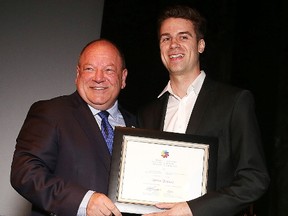 Mayor Brian Bigger presents Jamie Dupuis with the Outstanding Emerging Artist award at the Mayor's Celebration of the Arts at the Science North Vale Cavern on Thursday. Gino Donato/Sudbury Star