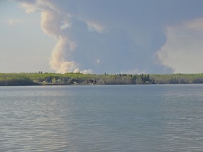Smoke rises from a 300-hectare wildfire burning on the CFB Cold Lake Air Weapons Range. A 37-year-old male died fighting the fire when his single-seater water bomber crashed just after 4:30 p.m. on Friday, May 22 2015. Peter Lozinski photo/Cold Lake Sun/Postmedia Network