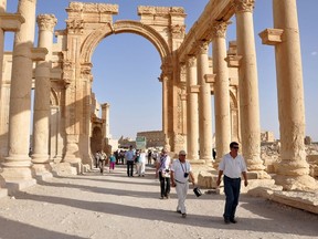 Tourists walk in the historical city of Palmyra, September 30, 2010. Islamic State fighters in Syria have entered the ancient ruins of Palmyra after taking complete control of the central city, but there are no reports so far of any destruction of antiquities, a group monitoring the war said on May 21, 2015. REUTERS/Nour Fourat