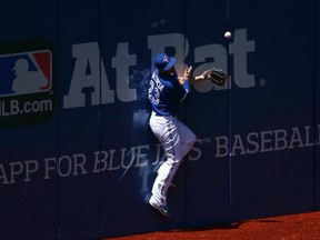 Blue Jays outfielder Danny Valencia cannot get to a two-run double off the wall during third inning MLB action against the Mariners in Toronto on Saturday, May 23, 2015. (Tom Szczerbowski/Getty Images/AFP)