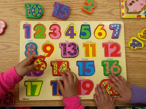 Children do a puzzle at the Jasper Place Child and Family Resource Centre, 16811 - 88 Ave., in Edmonton, Alta. on Thursday May 14, 2015. David Bloom/Edmonton Sun/Postmedia Network