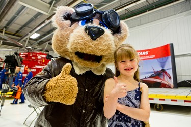 Emily-Page hangs out with STARS mascot Starbear during a public open house at the Winnipeg base. The Shock Trauma Air Rescue Society (STARS) opened their doors to the public Sat., May 23, 2015 as part of their 30th anniversary celebrations across western Canada. (Brook Jones/Postmedia Network)