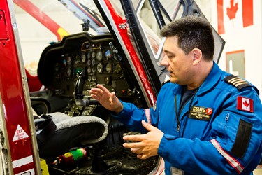 STARS pilot Jason Gaveline goes over safety features on one of the air ambulances during a public open house at the hanger located at 155 W Hangar Road in Winnipeg, Man., on Sat., May 23, 2015. (Brook Jones/Postmedia Network)