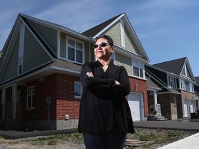 Ida Kakegumick stands in front of her new Habitat for Humanity house in the city. Thursday May 21, 2015. The house has changed the lives for her three grand children. Tony Caldwell/Ottawa Sun/Postmedia Network