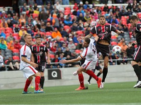 Ottawa Fury FC defender Colin Falvey, right, tries to knock down a ball in the Indy Eleven box Saturday as teammates Carl Haworth, left, and Raphael Alves look on during Saturday's game at TD Place. (Chris Hofley/Ottawa Sun)