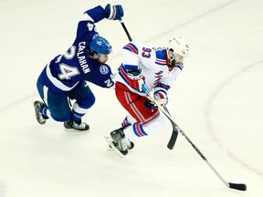 Rangers defenceman Keith Yandle (right) carries the puck away from Lightning right wing Ryan Callahan (left) during Game 4 of the Eastern Conference final in Tampa, Fla., on Friday, May 22, 2015. (Kim Klement/USA TODAY Sports)