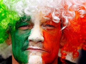 A man with the colours of the Irish flag painted on his face. 

REUTERS/Cathal McNaughton
