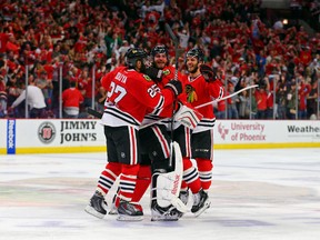 Chicago Blackhawks left wing Brandon Saad (20) and goalie Corey Crawford (50) and defenseman Johnny Oduya (27) and defenseman Niklas Hjalmarsson (4) celebrate their victory over the Anaheim Ducks during the second overtime period in game four of the Western Conference Final of the 2015 Stanley Cup Playoffs at United Center. The Chicago Blackhawks won 5-4 in two overtimes.

USA TODAY