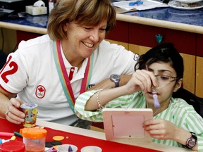 1984 Summer Olympics silver medalist Sue Hollaway makes crafts with 13-year-old Zahra Easa as a number of Canadian medallists visited the Stollery Children's Hospital in  October  2012. TOM BRAID/EDMONTON SUN /QMI AGENCY