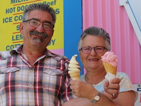 Frank and Frima Olszynko hold up ice cream cones outside Lois 'n' Frimas Homemade Ice Cream on Sunday, May, 24/ 2015. This summer any customer can pay-it-forward to another person in need when they purchase food at the ice cream shop in the Byward Market. The initiative is in honour of their friend Pete. 
(Keaton Robbins/Ottawa Sun)