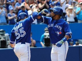 Toronto Blue Jays designated hitter Edwin Encarnacion (10) celebrates with catcher Russell Martin (55) after he hit a two run homer against Seattle Mariners in the fifth inning at Rogers Centre. (Peter Llewellyn-USA TODAY Sports)