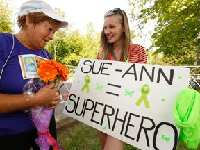 Paige Spencer (R) - who has been battling chronic Lyme disease - shows her support to Toronto Sun columnist Sue-Ann Levy after she ran the Toronto Women's Half Marathon and dedicated her run to Paige raising awareness for the disease on Sunday May 24, 2015 at Sunnybrook Park. (Jack Boland/Toronto Sun)